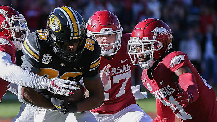 Missouri wide receiver Tauski Dove tries to shake free from Hayden Henry and Montaric Brown against Arkansas in a 2021 loss.